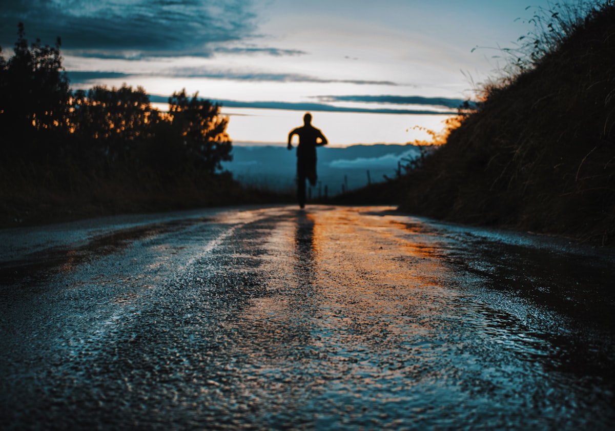Active person walking along a scenic nature trail for wellness and health